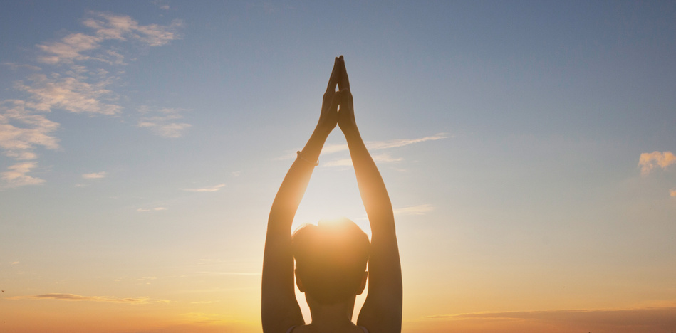 Woman practicing yoga, sunset. Healing concept